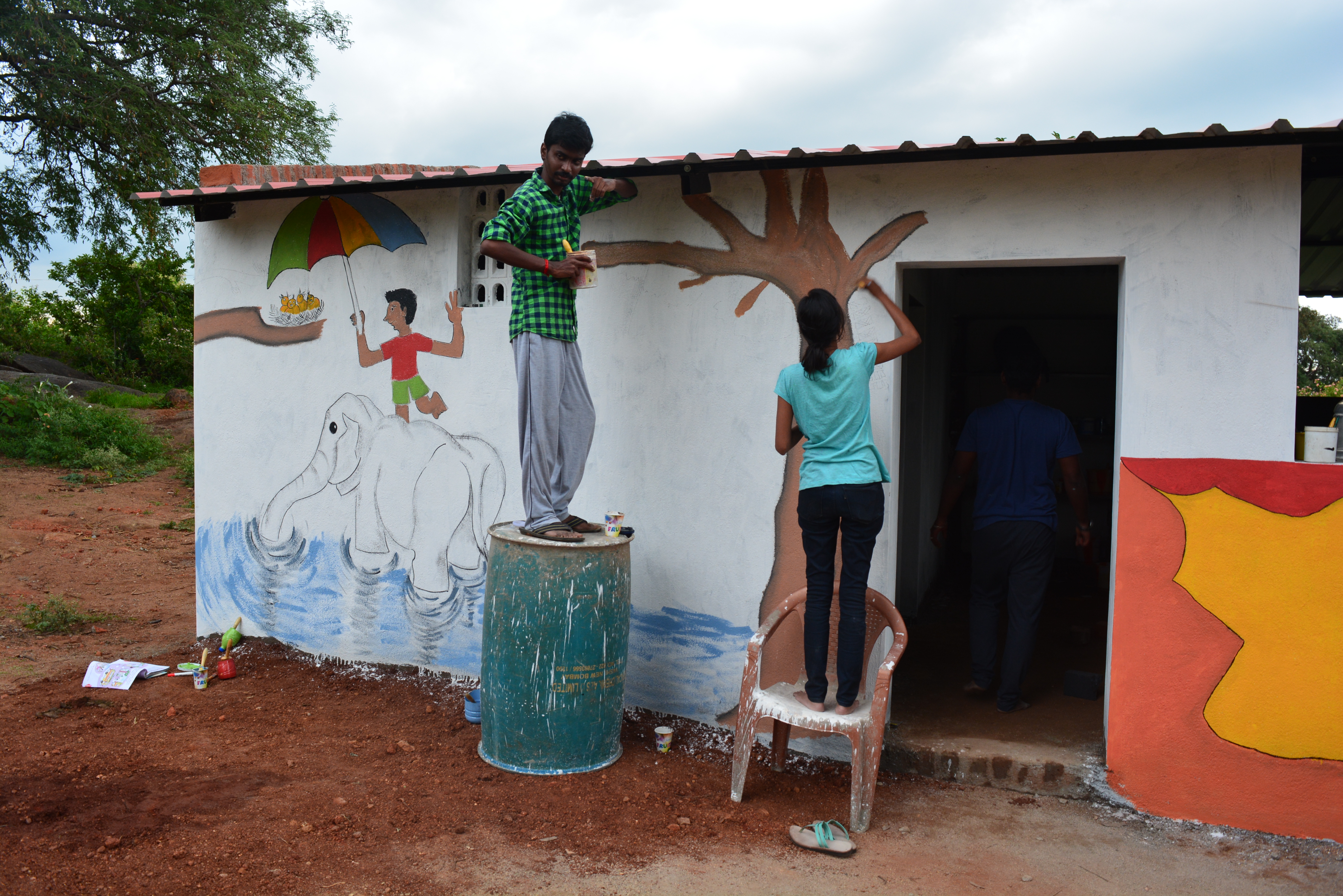 Prayag volunteers painting a school building in Jawadhi