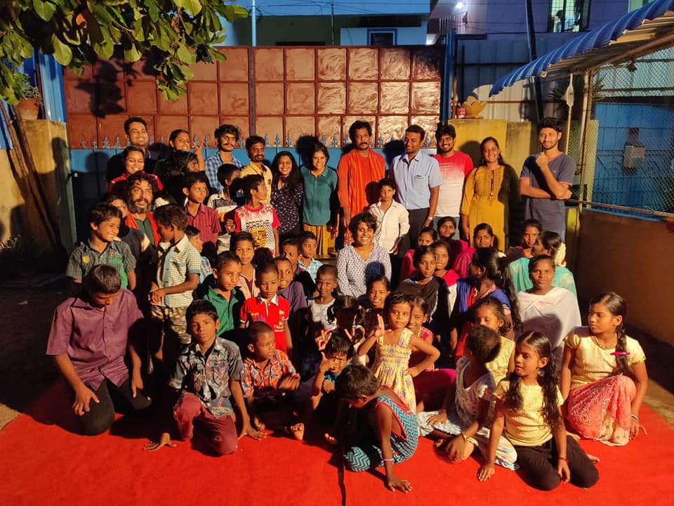 Prayag volunteers and children together at an evening event