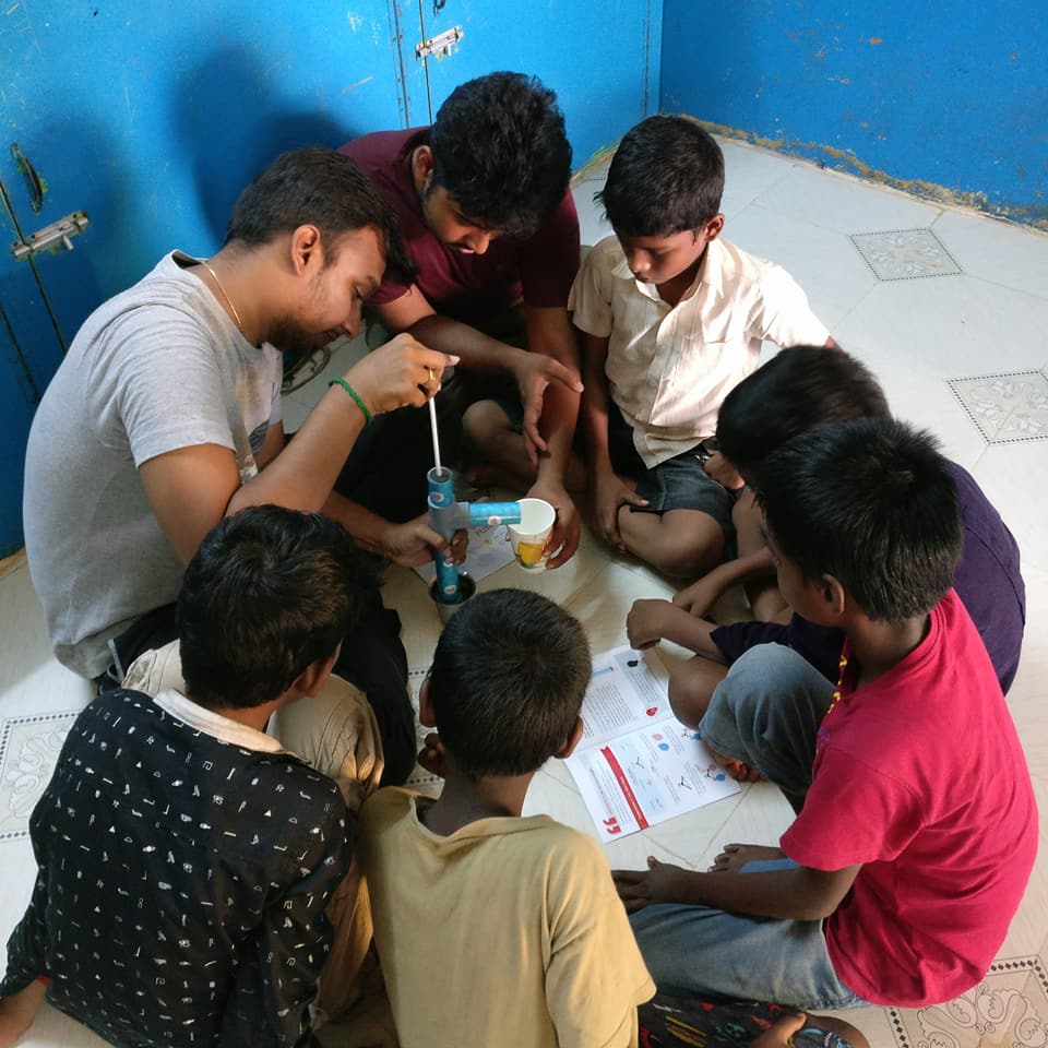 Volunteer-led STEM activity with children sitting in a circle