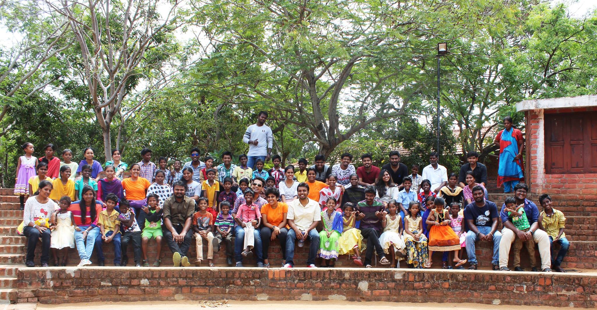 Children, volunteers, and families gathered together during a Prayag community day