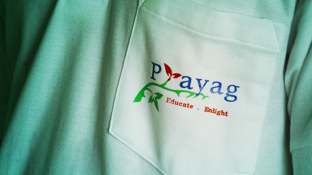 Close-up of Prayag branding on a volunteer shirt